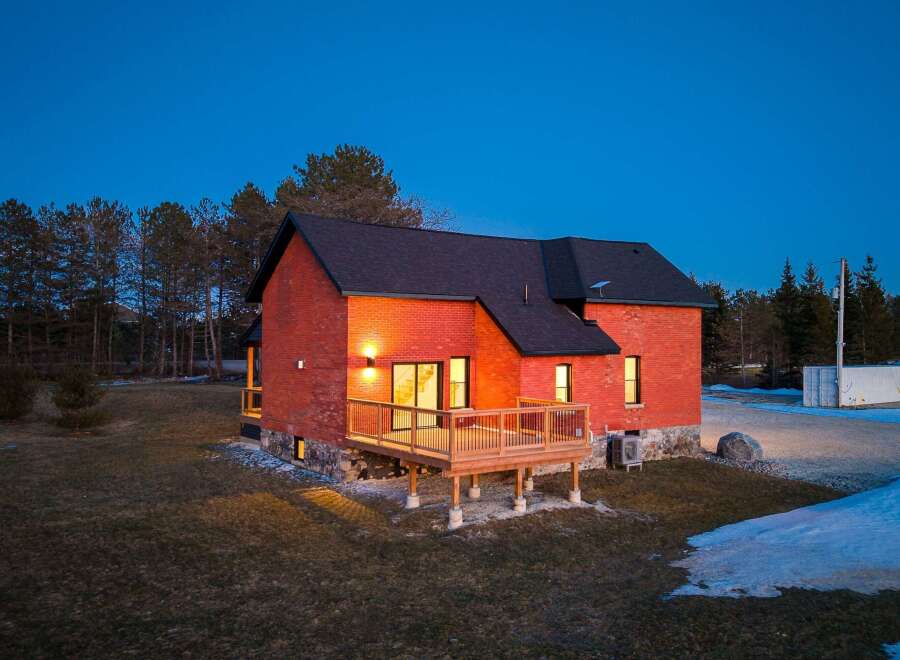 This stunning brick home offers a perfect blend of modern design and natural surroundings.