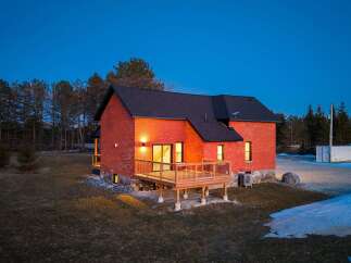This stunning brick home offers a perfect blend of modern design and natural surroundings.