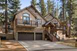This stunning property boasts a rustic exterior with a combination of wood and stone, creating a warm and inviting atmosphere.