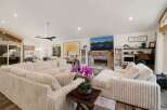 Step into luxury with this stunning living room, featuring a cozy sectional sofa and a beautiful fireplace.