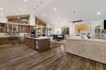 This stunning kitchen and living space offers a seamless blend of modern design and rustic charm.