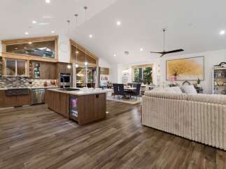 This stunning kitchen and living space offers a seamless blend of modern design and rustic charm.