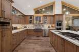 This stunning kitchen boasts custom cabinetry, offering ample storage and a warm, inviting atmosphere.