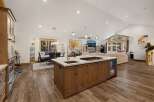 This stunning open-concept home boasts a gourmet kitchen with a large island, perfect for entertaining.