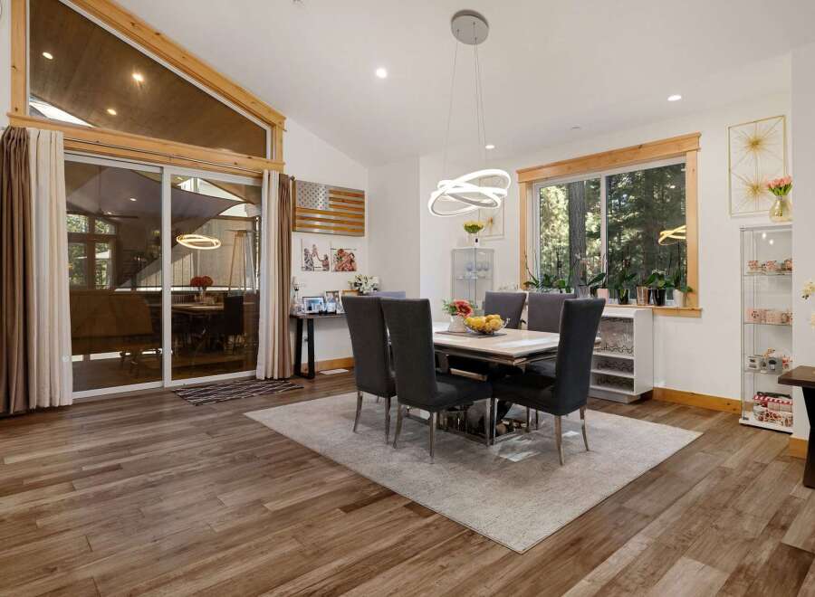 Step into luxury with this stunning dining room, featuring a modern design and ample natural light.