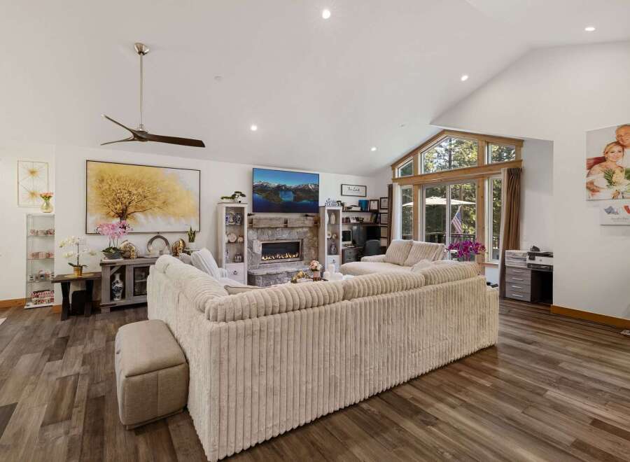 Step into luxury with this stunning living room, featuring a cozy fireplace and a large, comfortable sofa perfect for gatherings.