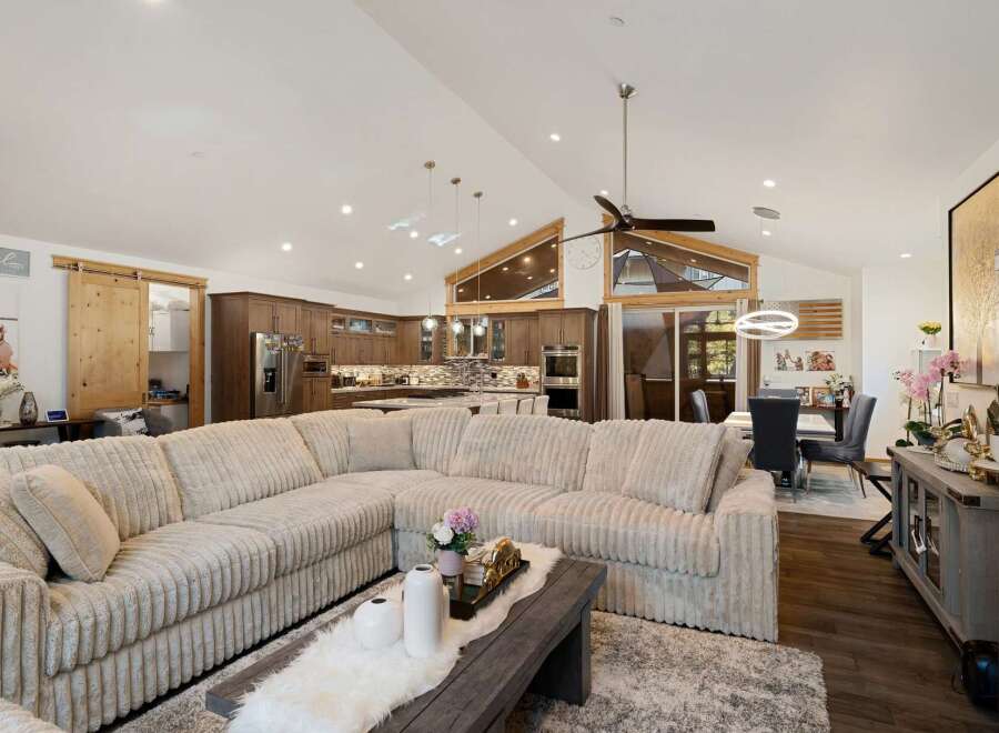 Step into luxury with this stunning open-concept home! Featuring a gourmet kitchen, a cozy living area with a plush sectional, and a dining space perfect for entertaining.