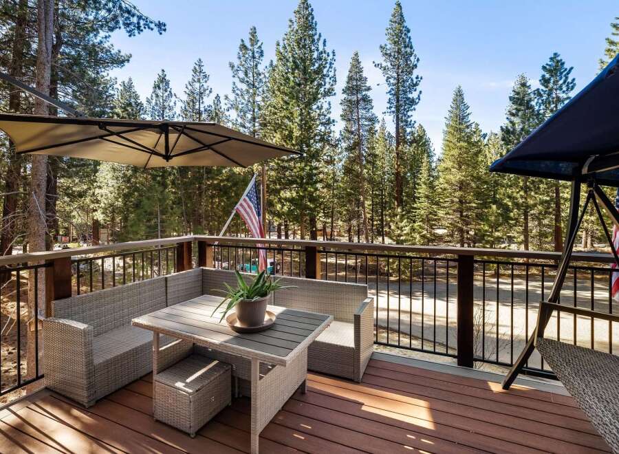 Enjoy the tranquility of nature from this stunning deck! This property features a comfortable outdoor seating area, perfect for relaxing and entertaining.