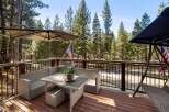 Enjoy the tranquility of nature from this stunning deck! This property features a comfortable outdoor seating area, perfect for relaxing and entertaining.