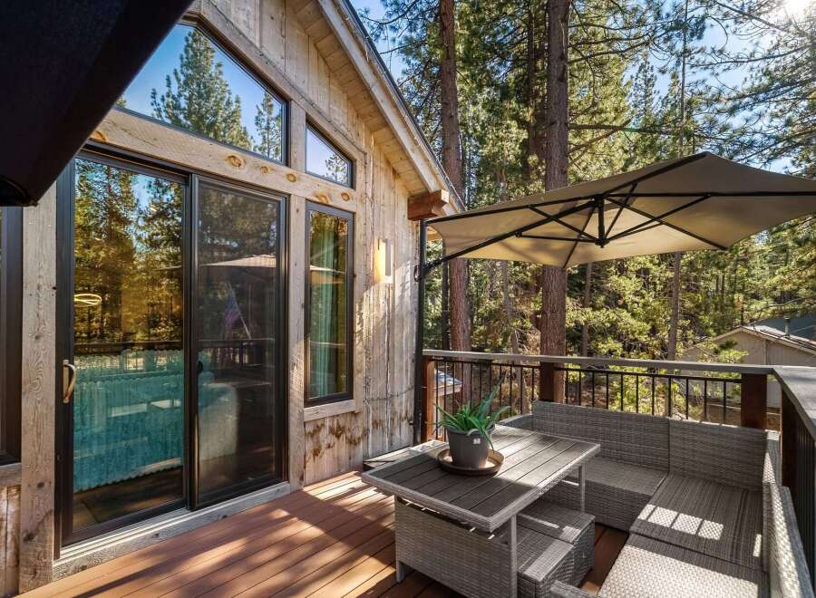 Enjoy the tranquility of this stunning cabin with a beautiful deck overlooking a lush forest.