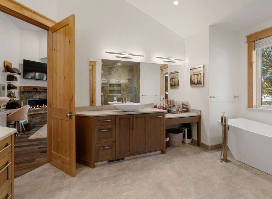 This luxurious bathroom boasts a modern design with a spacious vanity and a sleek, contemporary bathtub.