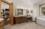 This luxurious bathroom boasts a modern design with a spacious vanity and a sleek, contemporary bathtub.