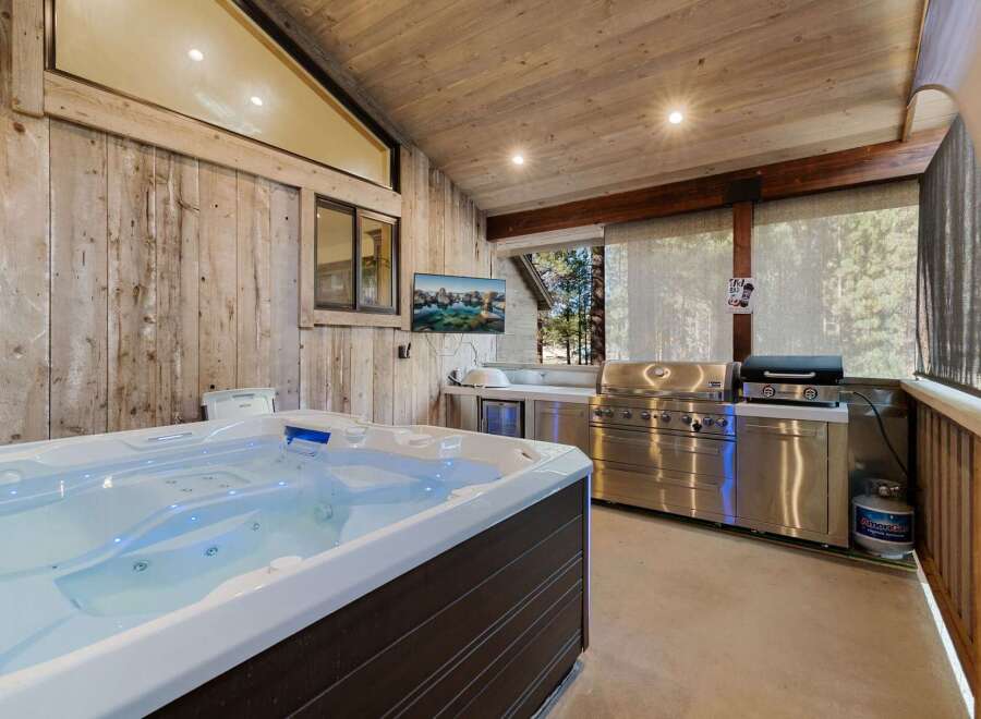 Relax and unwind in this luxurious outdoor space, complete with a hot tub and a fully equipped outdoor kitchen.
