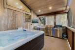 Relax and unwind in this luxurious outdoor space, complete with a hot tub and a fully equipped outdoor kitchen.