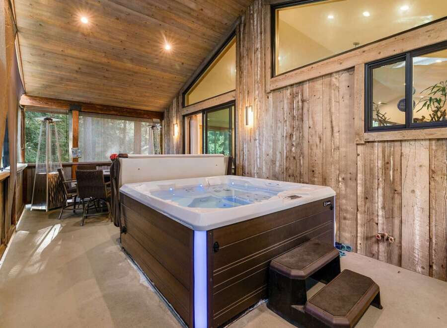 Relax and unwind in this luxurious outdoor space featuring a stunning hot tub.