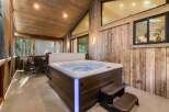 Relax and unwind in this luxurious outdoor space featuring a stunning hot tub.
