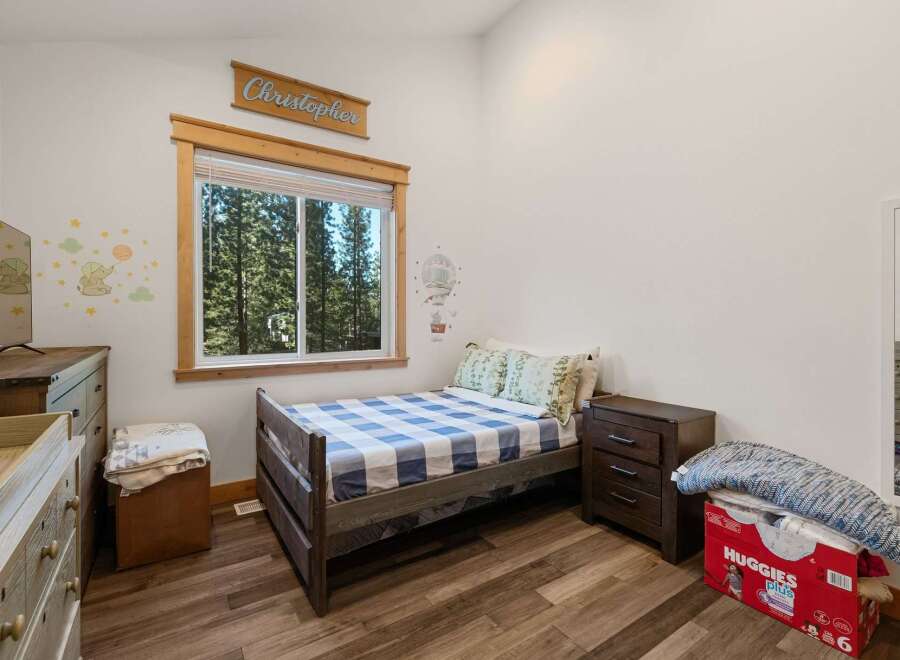 This charming bedroom features a cozy bed with a stylish checkered pattern, perfect for a comfortable night's sleep.