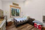 This charming bedroom features a cozy bed with a stylish checkered pattern, perfect for a comfortable night's sleep.