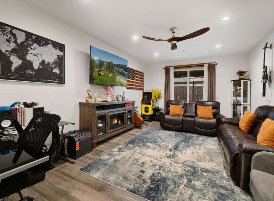 Step into luxury and comfort in this stunning living room! Featuring a cozy fireplace, a large TV, and a stylish rug, this space is perfect for relaxation and entertainment.