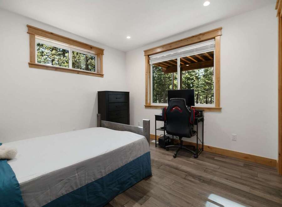 This inviting bedroom features a comfortable bed and ample natural light.