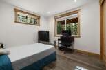 This inviting bedroom features a comfortable bed and ample natural light.