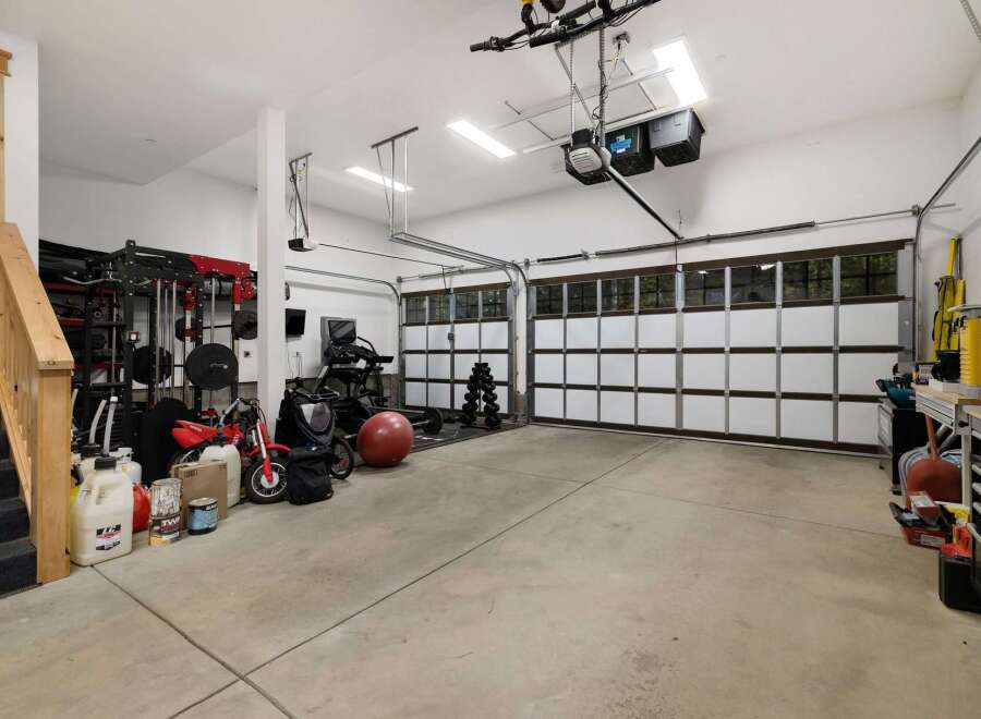 This spacious garage offers ample room for vehicles and storage, perfect for a car enthusiast or a homeowner needing extra space.