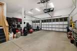 This spacious garage offers ample room for vehicles and storage, perfect for a car enthusiast or a homeowner needing extra space.