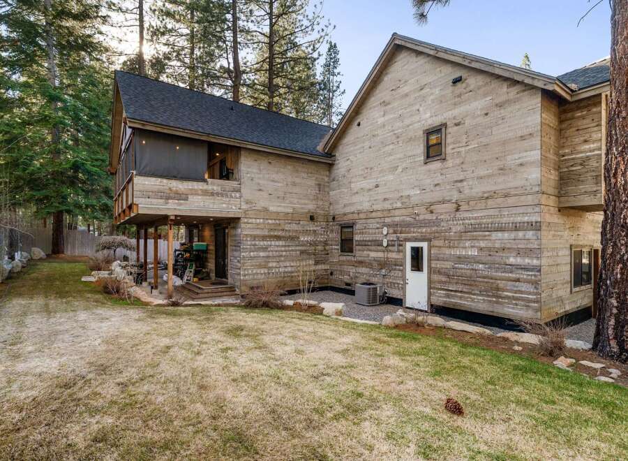 Discover the charm of this stunning property, featuring a unique wooden exterior and a serene outdoor space.
