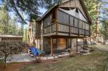 Nestled in a serene wooded setting, this stunning property boasts a unique architectural design with a raised deck and screened-in porch.