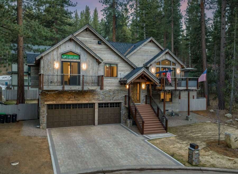 This stunning mountain home boasts a rustic exterior with a charming wooden facade and stone accents.