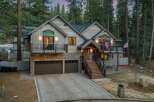 This stunning mountain home boasts a rustic exterior with a charming wooden facade and stone accents.