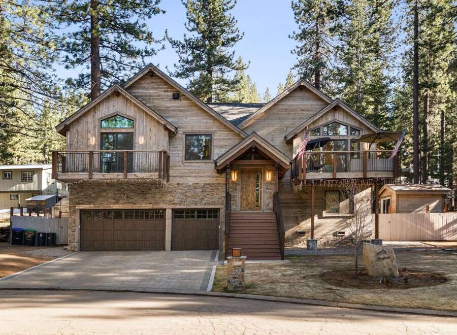 This stunning mountain home boasts a rustic charm with its wood and stone exterior, offering a warm and inviting atmosphere.