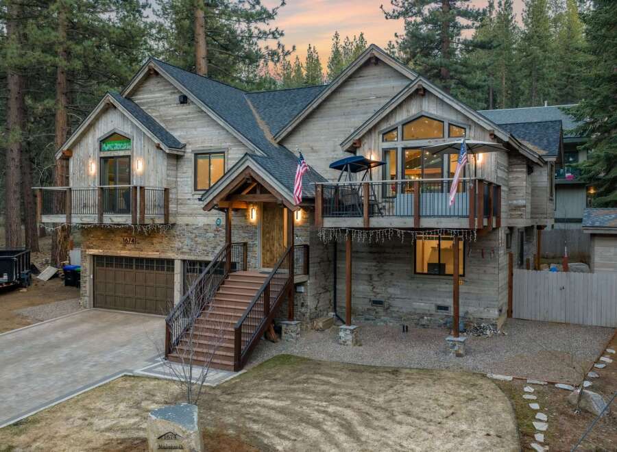 This stunning property boasts a rustic exterior with a charming wooden facade and stone accents.