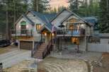 This stunning property boasts a rustic exterior with a charming wooden facade and stone accents.