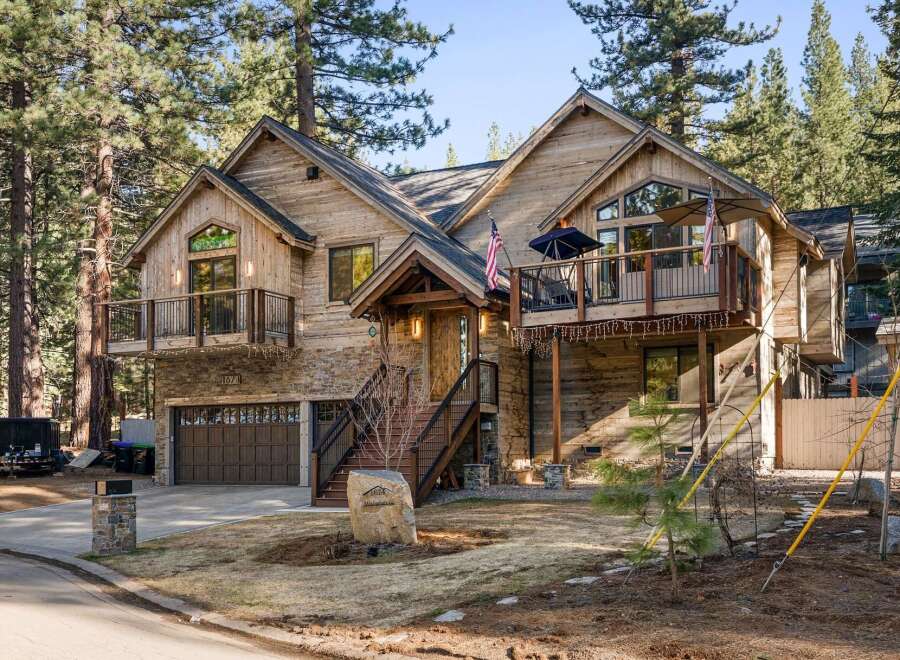 Nestled amidst towering trees, this stunning wooden cabin offers a serene retreat.