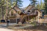 Nestled amidst towering trees, this stunning wooden cabin offers a serene retreat.