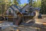 This stunning property boasts a rustic exterior with a blend of wood and stone, creating a warm and inviting atmosphere.
