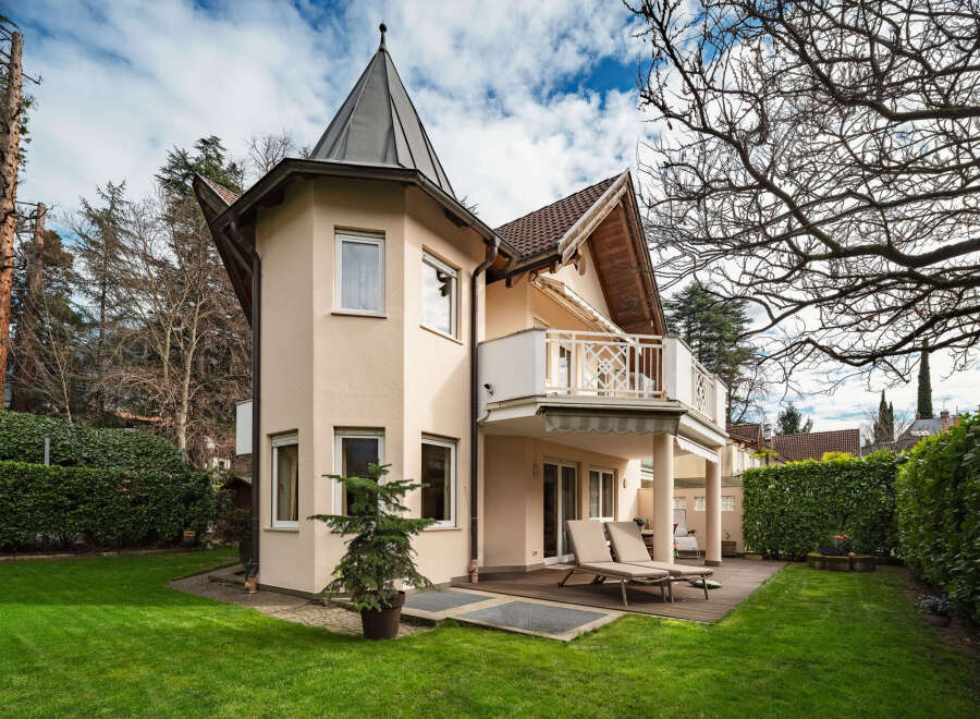 This stunning property boasts a unique architectural design, featuring a charming turret and a spacious balcony.