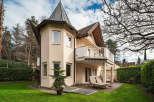 This stunning property boasts a unique architectural design, featuring a charming turret and a spacious balcony.