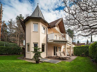 This stunning property boasts a unique architectural design, featuring a charming turret and a spacious balcony.