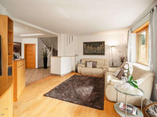 Step into luxury with this stunning living room, featuring a modern design and ample natural light.