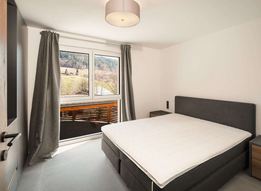 This stunning bedroom boasts a modern design with a comfortable bed and a serene ambiance.