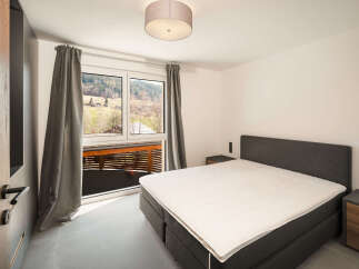 This stunning bedroom boasts a modern design with a comfortable bed and a serene ambiance.