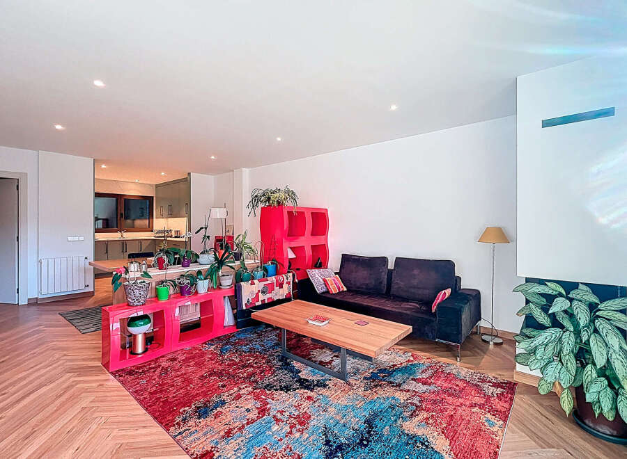 This stunning property boasts a modern living space with a vibrant, colorful rug that adds a pop of personality.