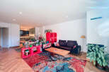 This stunning property boasts a modern living space with a vibrant, colorful rug that adds a pop of personality.