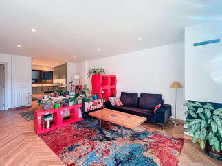 This stunning property boasts a modern living space with a vibrant, colorful rug that adds a pop of personality.