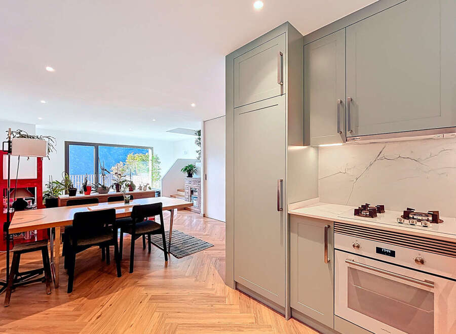 This stunning property boasts a modern kitchen with sleek cabinetry and high-end appliances, perfect for culinary enthusiasts.