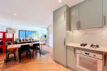This stunning property boasts a modern kitchen with sleek cabinetry and high-end appliances, perfect for culinary enthusiasts.