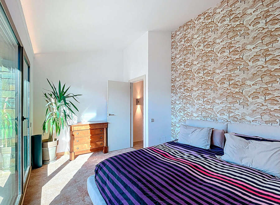 This stunning bedroom boasts a unique blend of modern design and natural elements.