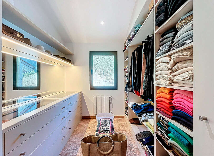 Step into luxury with this meticulously designed walk-in closet, offering ample storage and organization.
